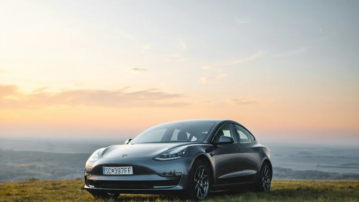 White Tesla Model 3 parked on a gravel overlook with fog-covered hills behind it
